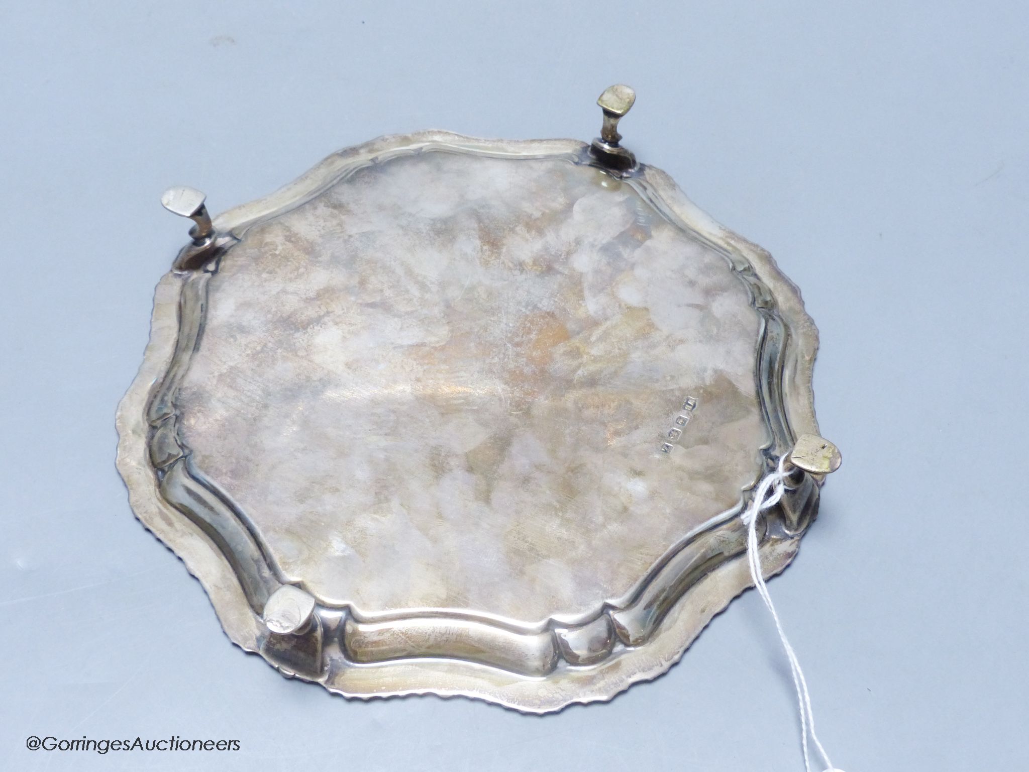 A circular silver waiter, with gadrooned piecrust edge, on four hoof feet, 11.46oz